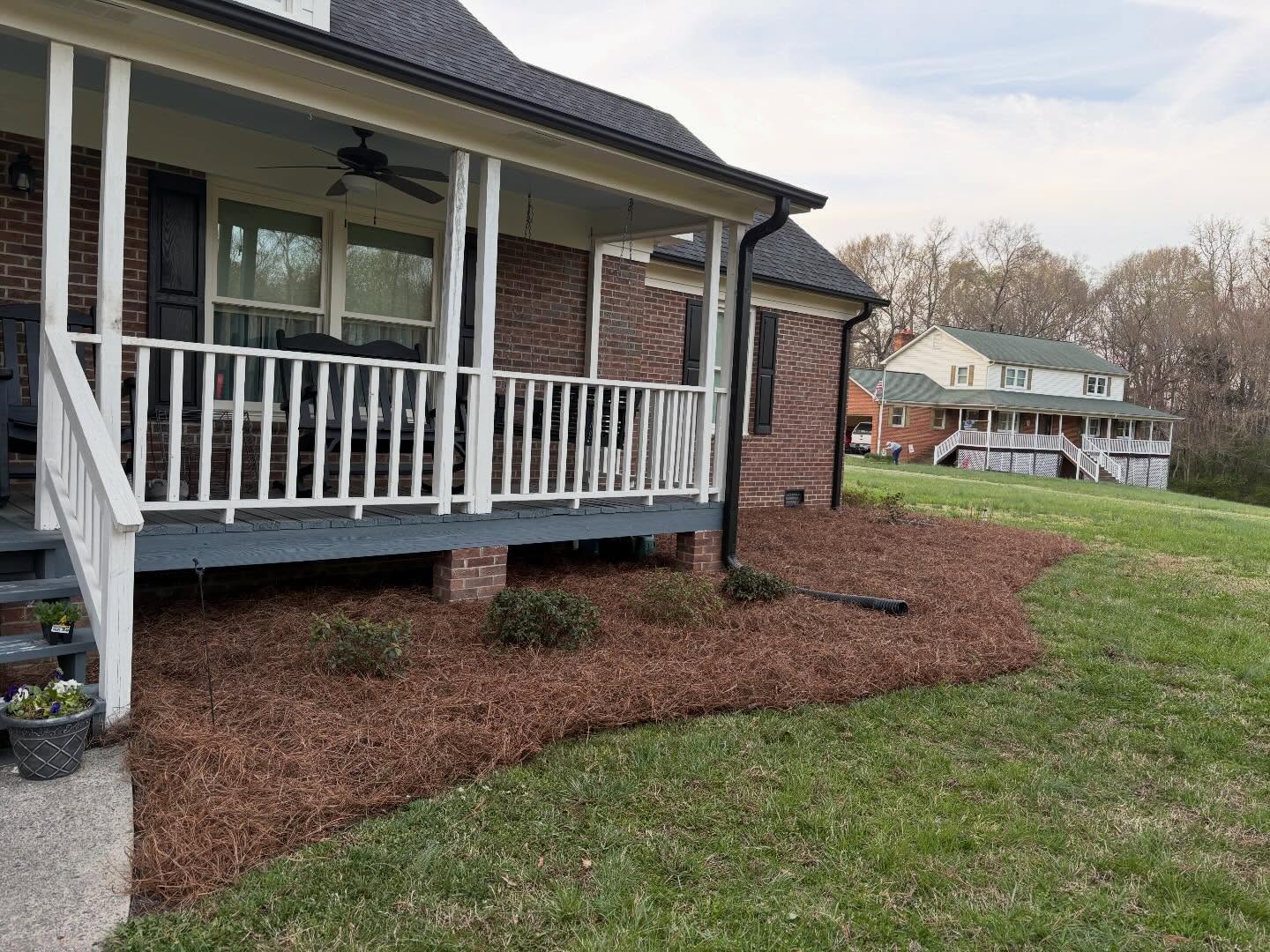 Fresh mulch bed along porch foundation